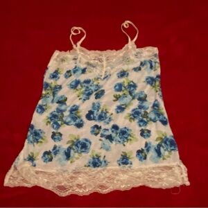 Spaghetti strap floral top. White lace with blue and green floral arrangement.